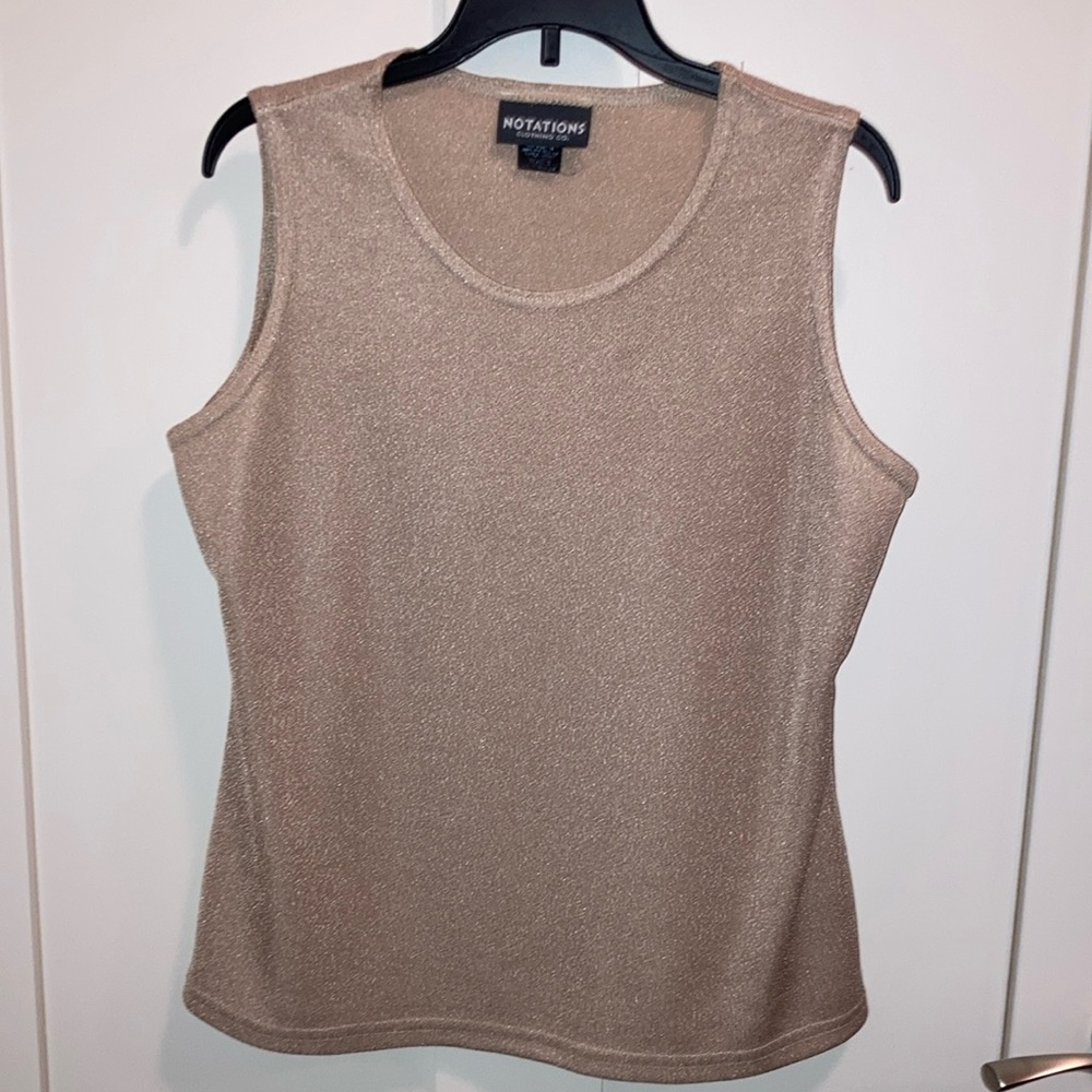 Women’s metallic beige top. Notations.